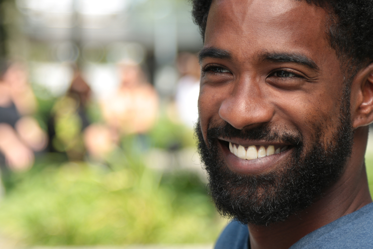 a man wearing glasses and smiling at the camera