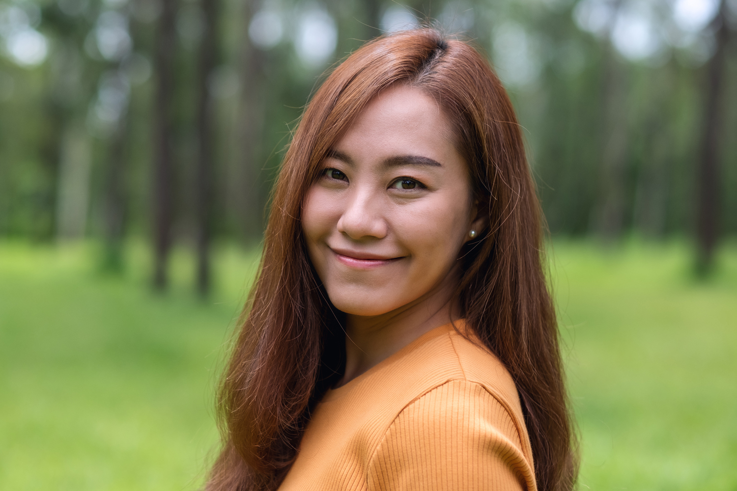 a woman wearing glasses and smiling at the camera