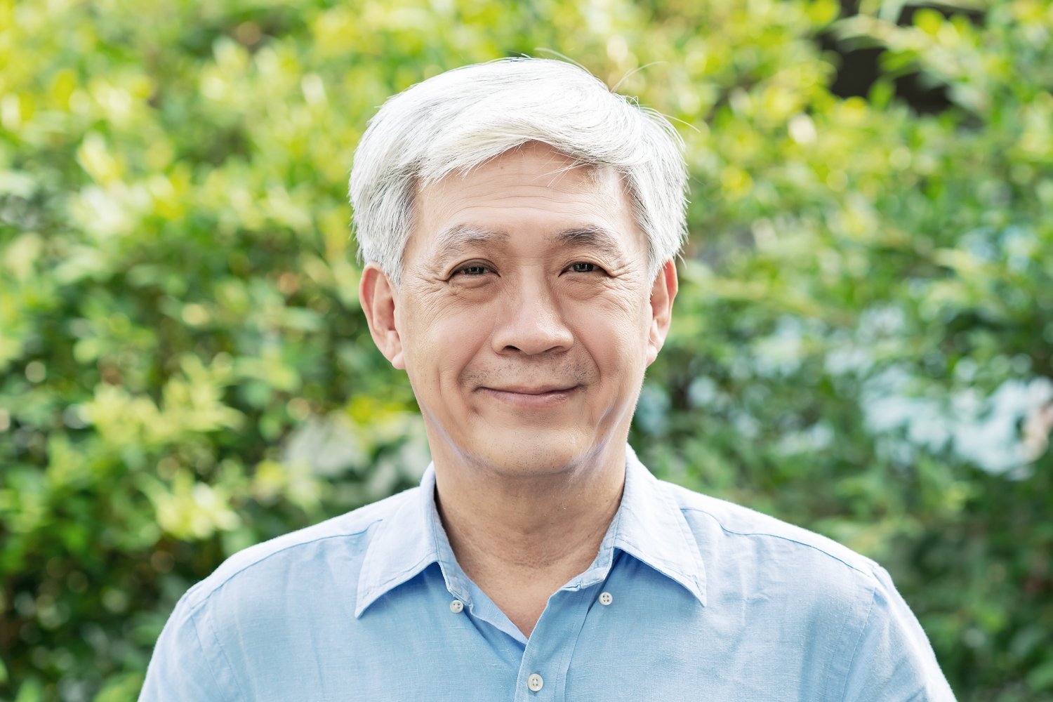 a man wearing a hat and smiling at the camera