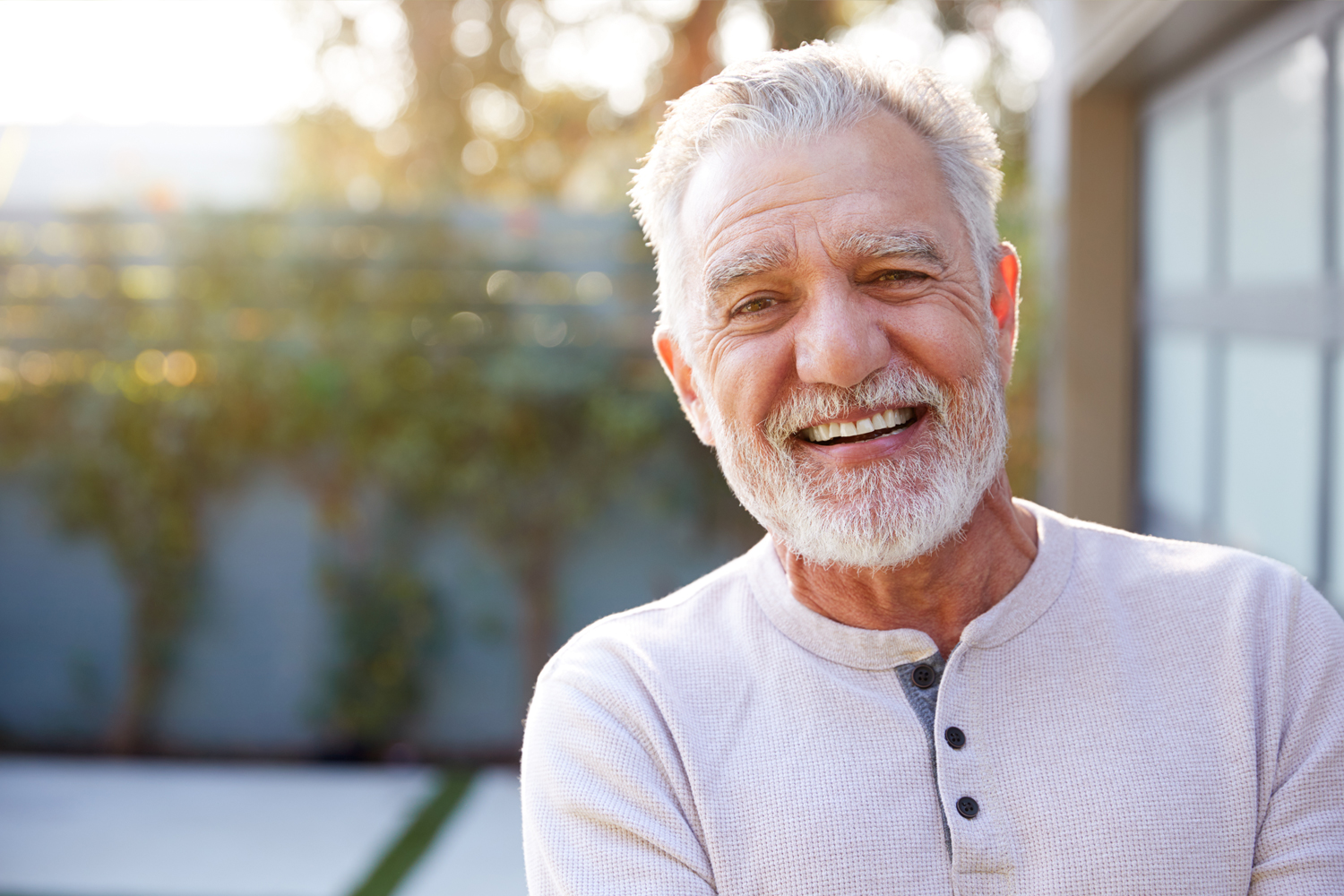 an older man smiling at the camera