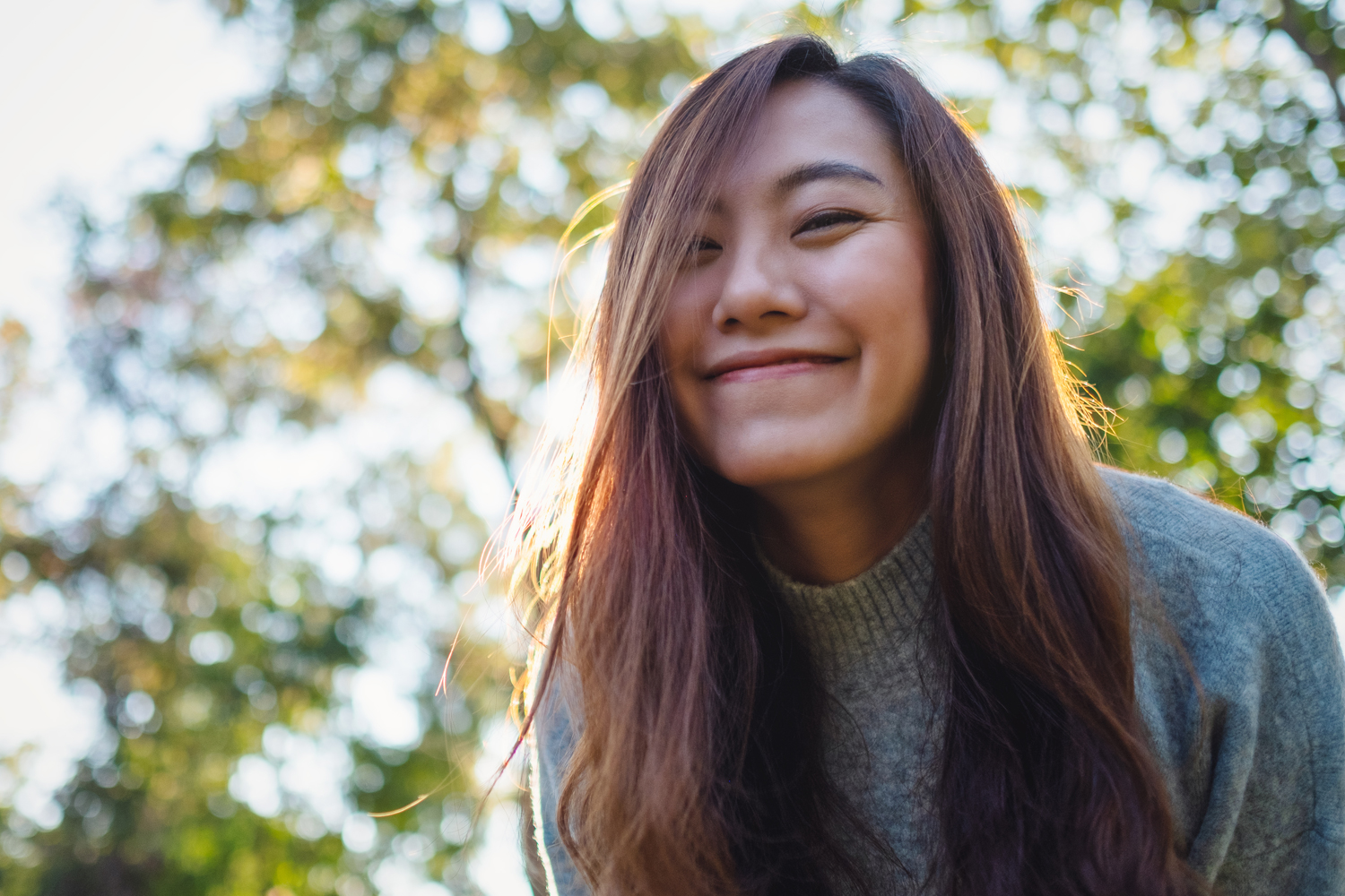 a close up of a woman standing outside smiling